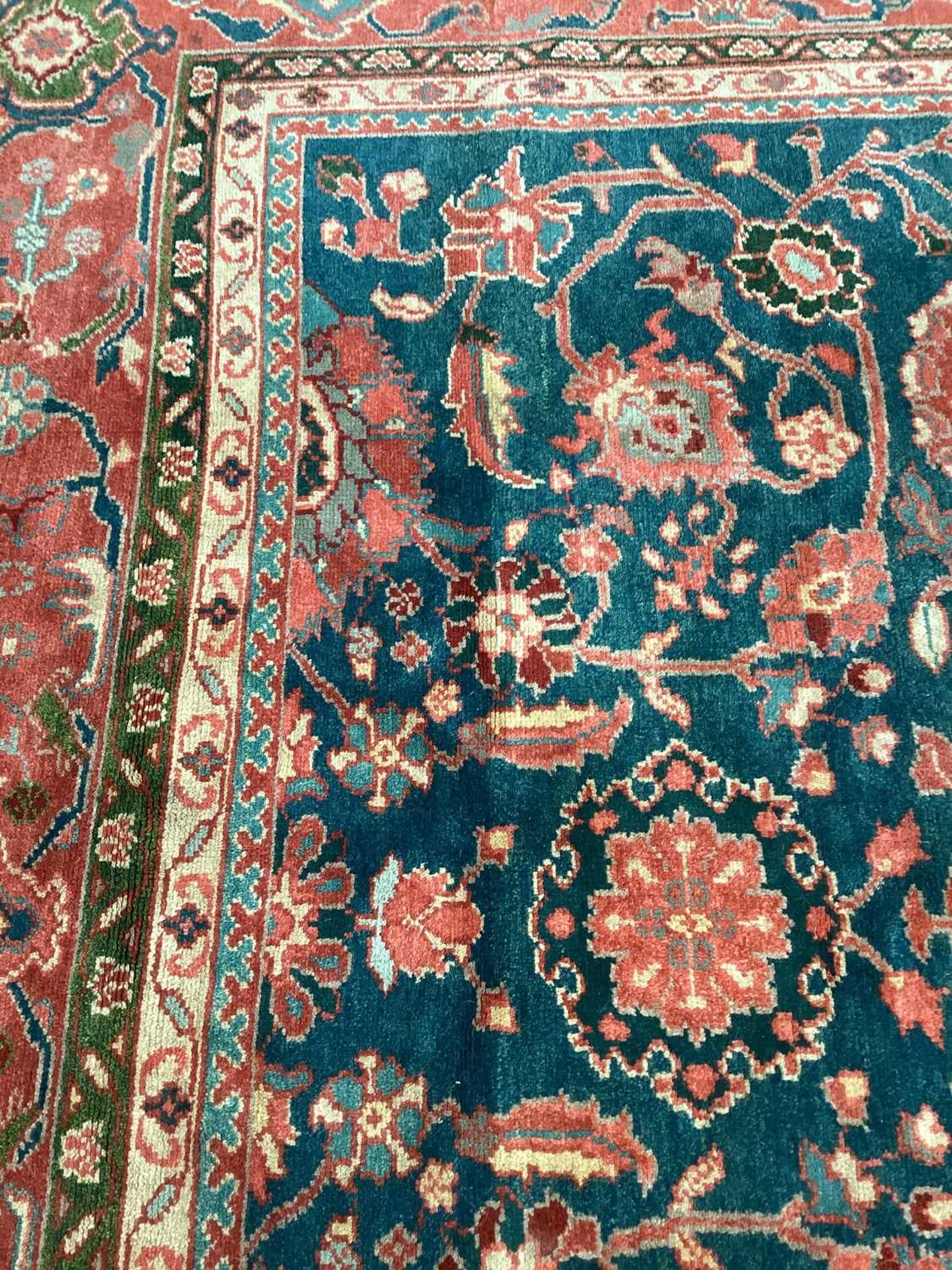 A large Ushak Carpet, the red palmette and leaf design on a blue/green field, within a light red bor - Image 12 of 23