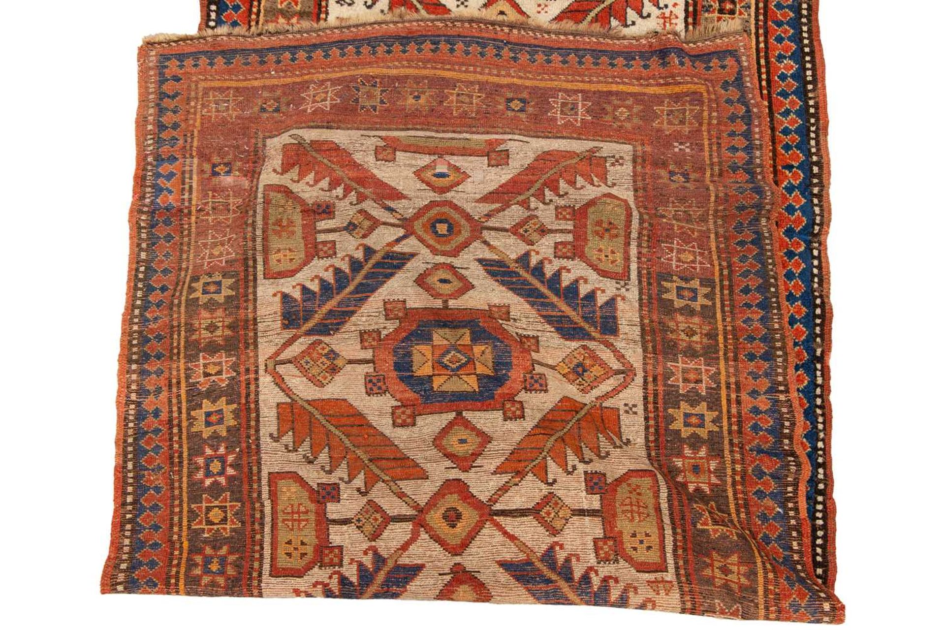 A Kazak Rug, the serrated leaf and medallion design on an ivory field, within a star and serrated bo - Image 2 of 6