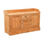 A North Country pine dresser, the three-quarter raised gallery over a central drawer and panelled cu