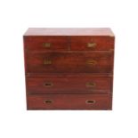 A late Victorian teakwood two-section campaign chest of two short over three long drawers, with sunk