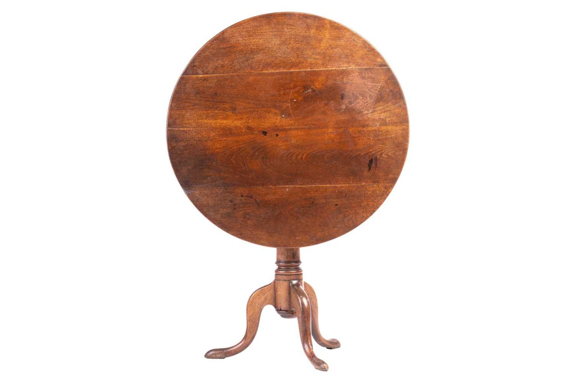 A 19th-century vernacular fruitwood snap-top tripod table, probably Welsh, with a planked top and bo