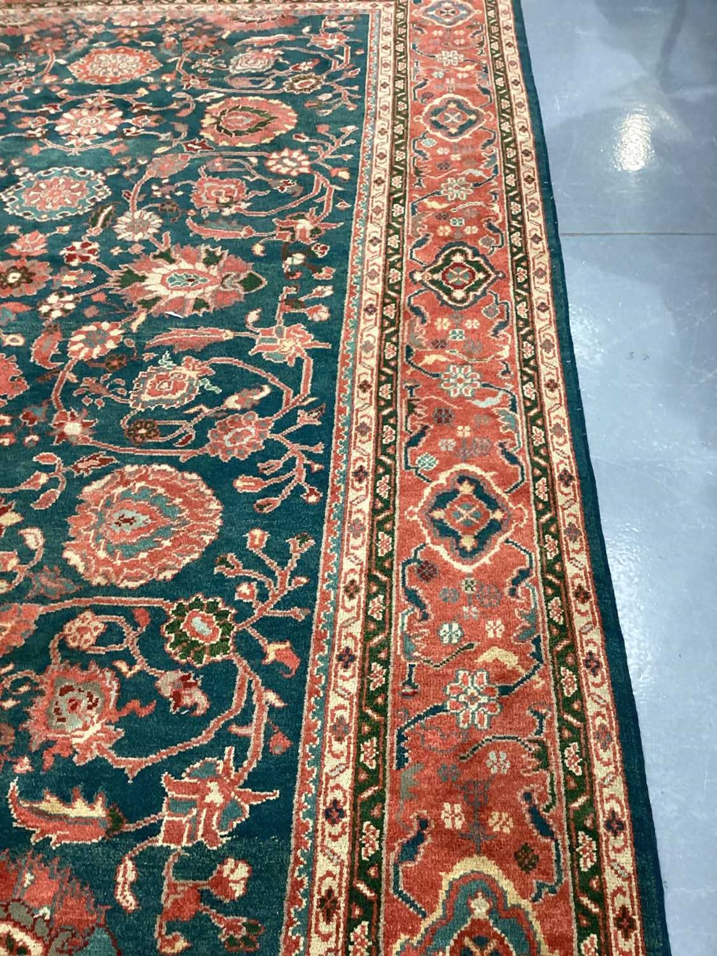 A large Ushak Carpet, the red palmette and leaf design on a blue/green field, within a light red bor - Image 18 of 23