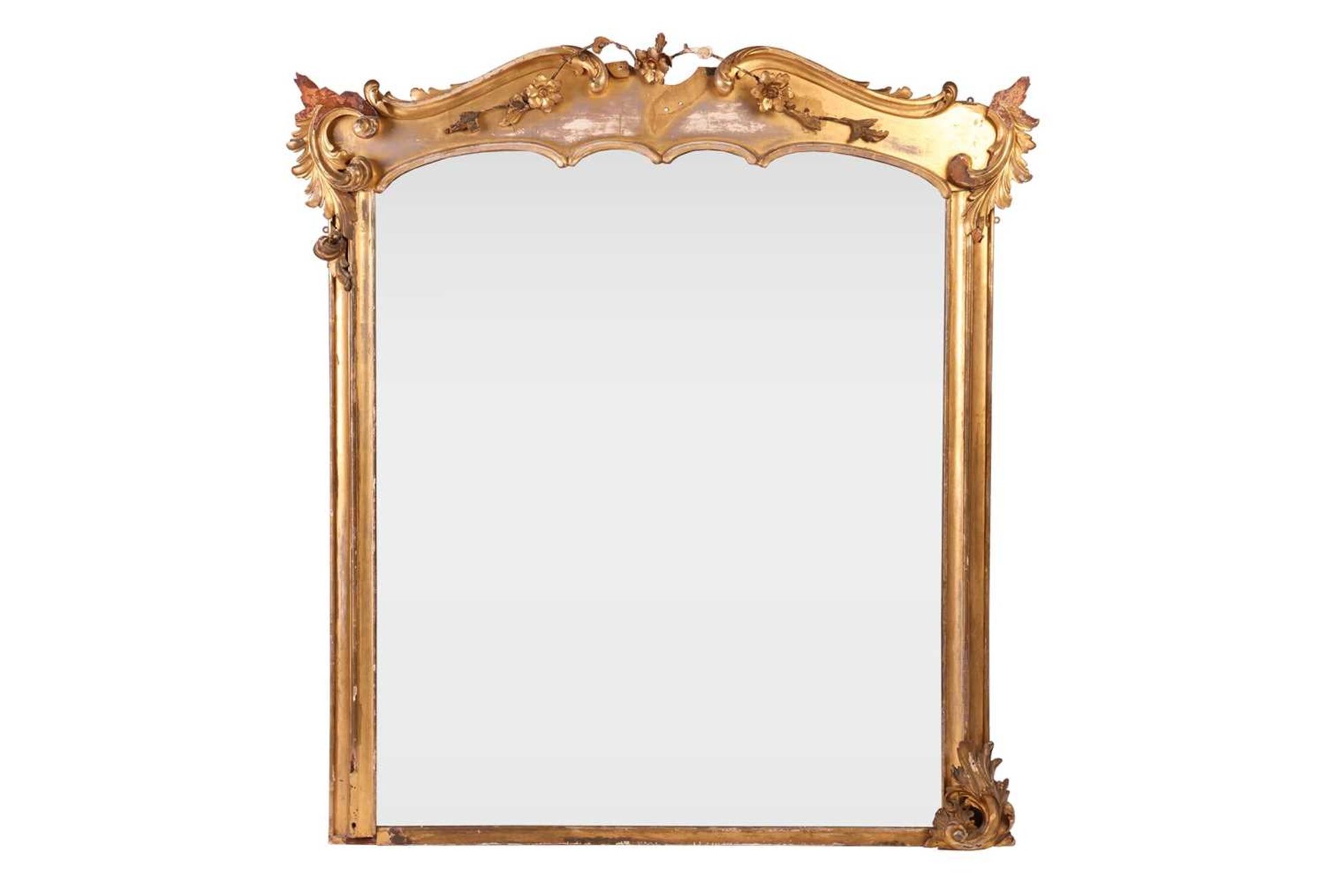 A 19th century giltwood overmantel mirror, the shaped top with applied floral sprays, foliate scroll