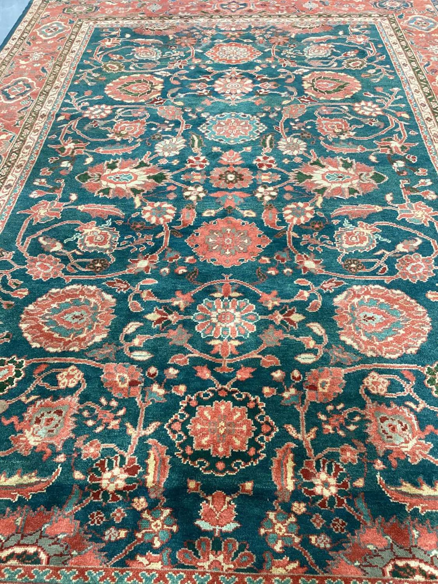 A large Ushak Carpet, the red palmette and leaf design on a blue/green field, within a light red bor - Image 17 of 23