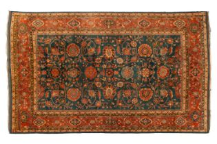 A large Ushak Carpet, the red palmette and leaf design on a blue/green field, within a light red