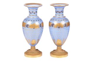 A pair of late 19th century French blue opaline glass and ormolu mounted vases, with gilt-overlaid