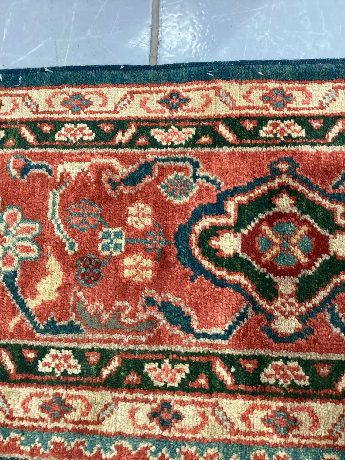 A large Ushak Carpet, the red palmette and leaf design on a blue/green field, within a light red bor - Image 11 of 23