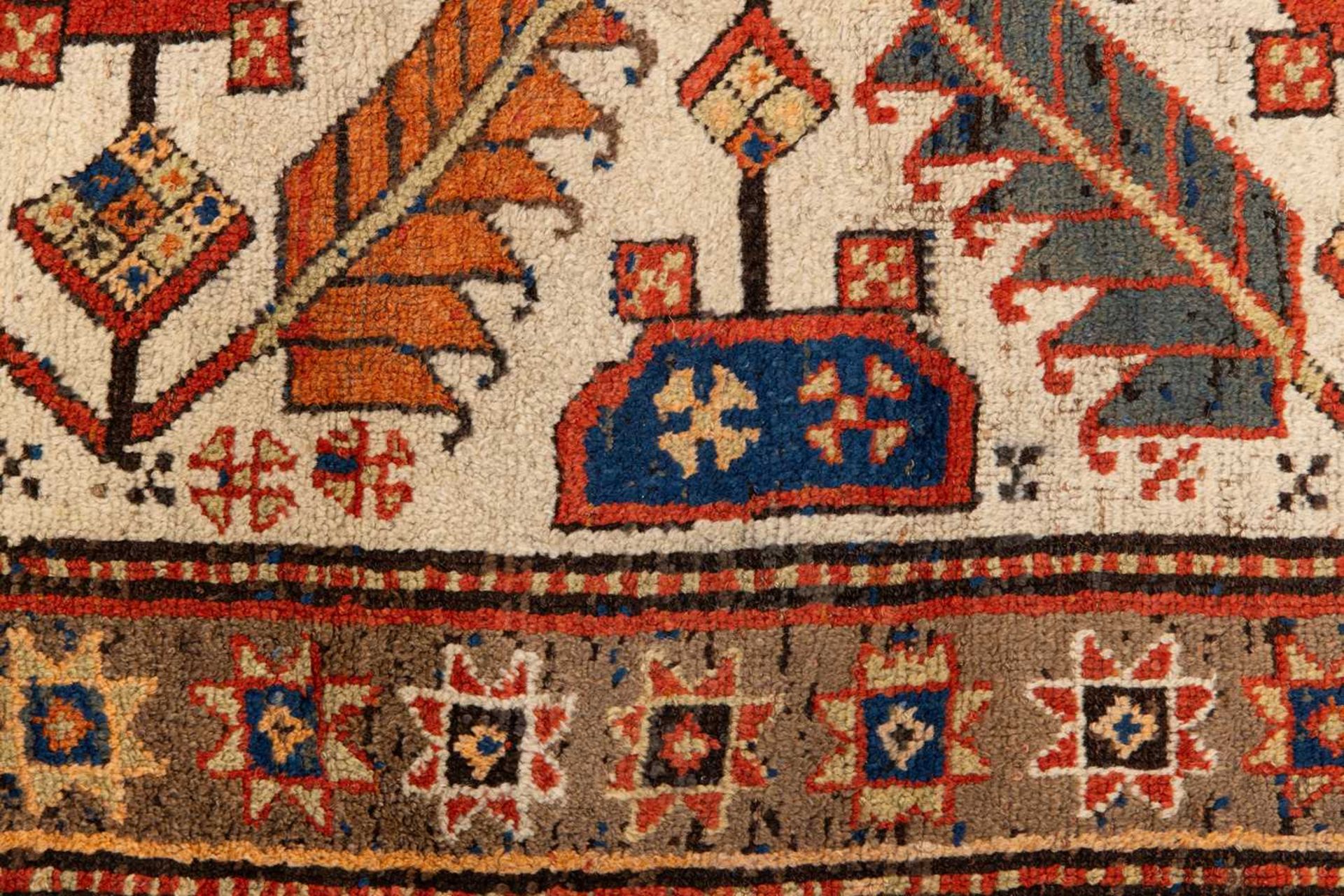 A Kazak Rug, the serrated leaf and medallion design on an ivory field, within a star and serrated bo - Image 5 of 6
