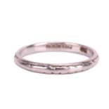 A wedding band engraved with foliage design, D-profile band in white metal marked 'Palladium', size 