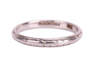 A wedding band engraved with foliage design, D-profile band in white metal marked 'Palladium',