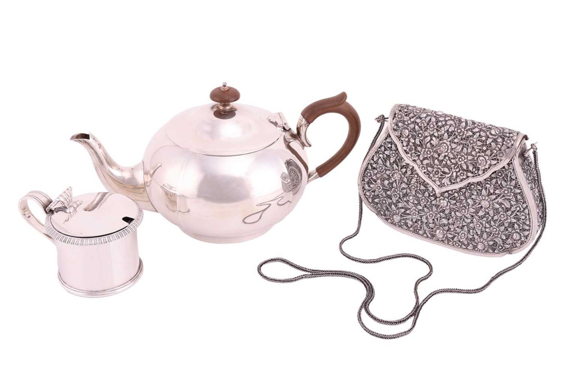 A silver teapot, circular panelled form with fruitwood handle and knop finial to domed cover. Sheffi