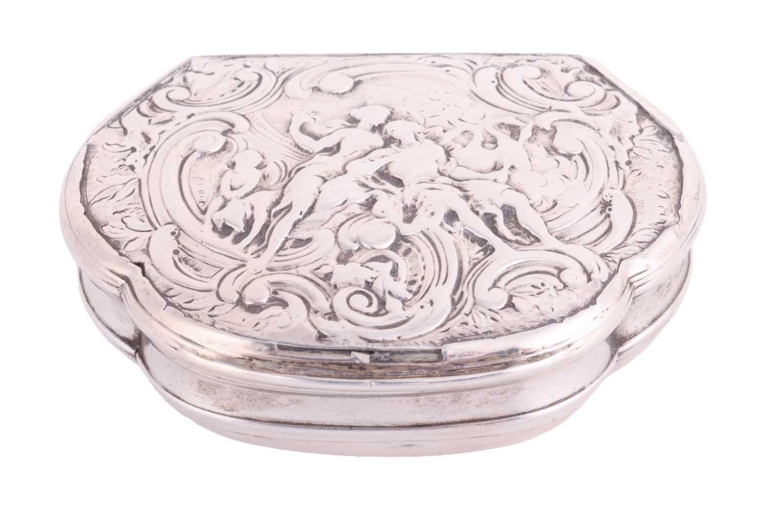 A Continental white metal snuff box of cartouche shape, circa 1740, cover chased with figures resemb