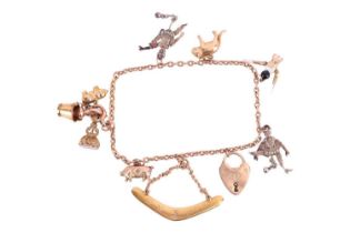 A charm bracelet featuring ten assorted charms, including examples of an Australian boomerang charm,