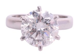 A diamond solitaire ring in platinum, claw-set with a round brilliant diamond approximately