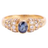 A sapphire and diamond ring, set with an oval sapphire measuring 4.8 x 4 x 2.5mm, the shoulders set 