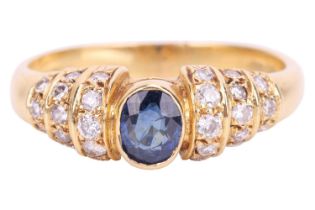 A sapphire and diamond ring, set with an oval sapphire measuring 4.8 x 4 x 2.5mm, the shoulders