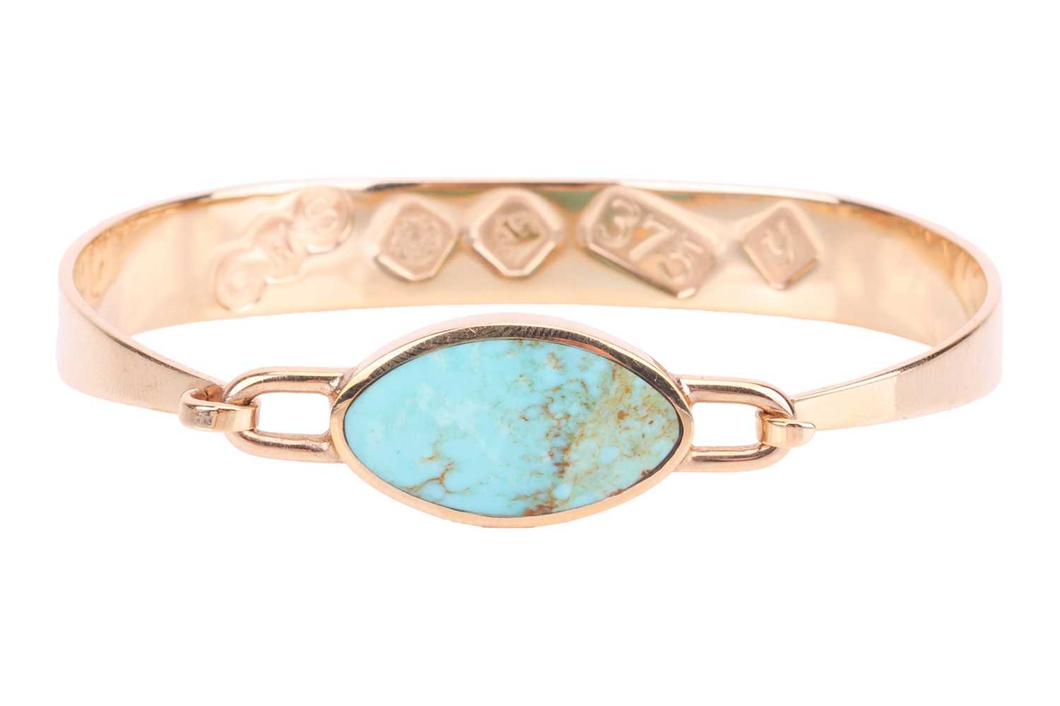 A turquoise-set bangle in 9ct yellow gold, tension clamp opening bracelet featuring a navette-shaped
