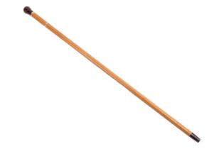 A Malacca walking cane with resin pommel, the connecting gold band with hallmarks for 12ct gold