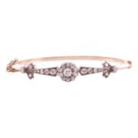 A late Victorian diamond hinged bangle, featuring a central cluster of old cut diamonds, between a t