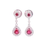 A pair of ruby and diamond cluster drop earrings, featuring pear-shaped rubies surrounded by round b