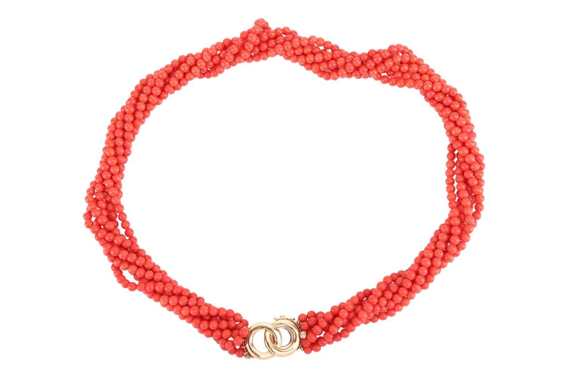 A coral torsade necklace, comprising seven strands of coral beads, completed with a clasp of annular