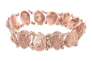A textured mollusc link bracelet; comprising fourteen links with chain link connections and a