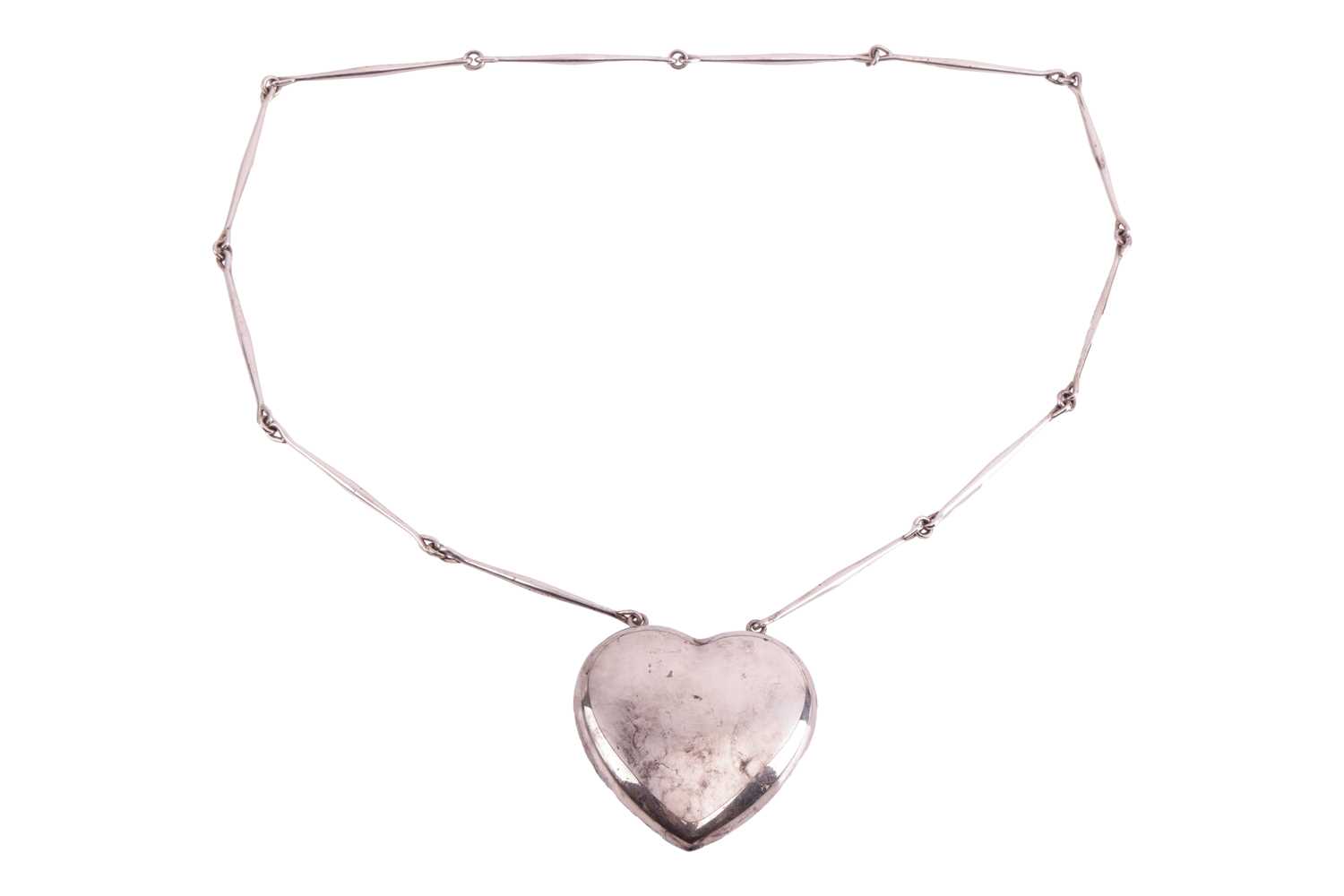 Georg Jensen - a large 'Joy' heart necklace, with a hollow heart-shaped pendant, attached to a serie