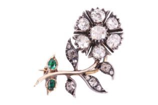 A Victorian diamond and emerald floral brooch, the naturalistically designed flower stem set with