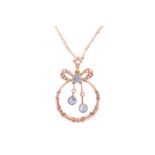 An Edwardian pendant on chain set with aquamarine and split pearls, of annular shape below a bow sur