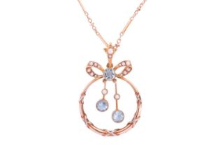 An Edwardian pendant on chain set with aquamarine and split pearls, of annular shape below a bow