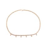 A diamond-set fringe necklace in 18ct yellow gold, comprising of a series of hayseed links with six 