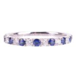 A sapphire and diamond half eternity ring in 18ct white gold, alternating with circular-cut sapphire