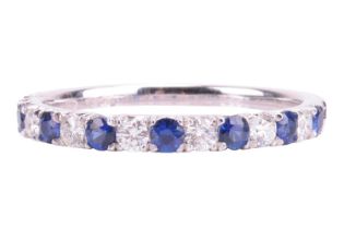 A sapphire and diamond half eternity ring in 18ct white gold, alternating with circular-cut