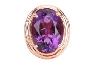 A large amethyst cocktail ring, centred with an oval-cut amethyst approximately measuring 20.1 x