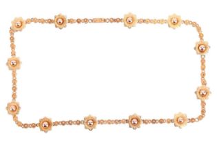 A fancy link necklace of floral design, the twelve individual flower links interspaced between