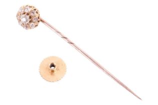 A 19th century diamond cluster stick pin convertible to dress stud, featuring an old cut diamond
