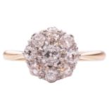 A diamond-set floral cluster ring, the central old-cut diamond measuring approximately 3.5mm and sur