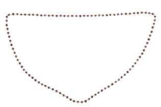 A long garnet bead endless necklace, consisting of a row of faceted garnet beads connected by jump