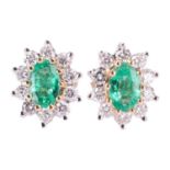 A pair of emerald and diamond cluster earrings, the central oval-cut emeralds measuring approximatel