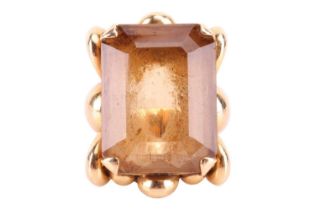 An Italian single stone smoky quartz dress ring; the rectangular step cut smoky quartz in corner