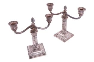 A pair of Norwegian two light candelabra, of Corinthian column design, with a pine cone capital, two