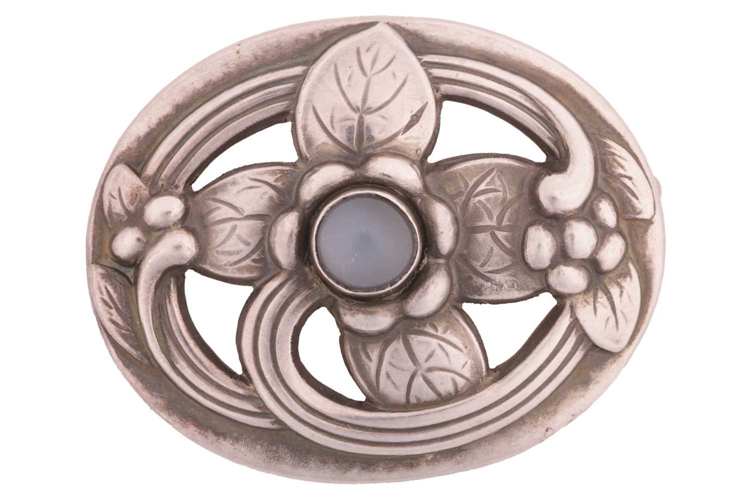 Georg Jensen - an oval floral brooch set with moonstone, openwork surround embossed and chased with 