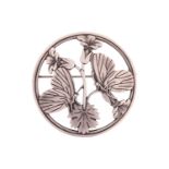 Georg Jensen - a round openwork brooch depicting two butterflies resting upon bellflowers, fitted wi