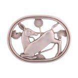 Georg Jensen - A brooch depicting kneeling fawn and flowers, fitted with hinged pin stem and roll-ov