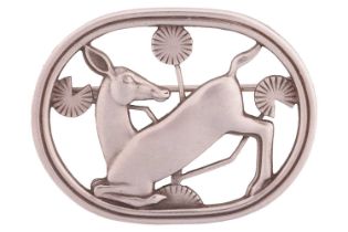 Georg Jensen - A brooch depicting kneeling fawn and flowers, fitted with hinged pin stem and roll-