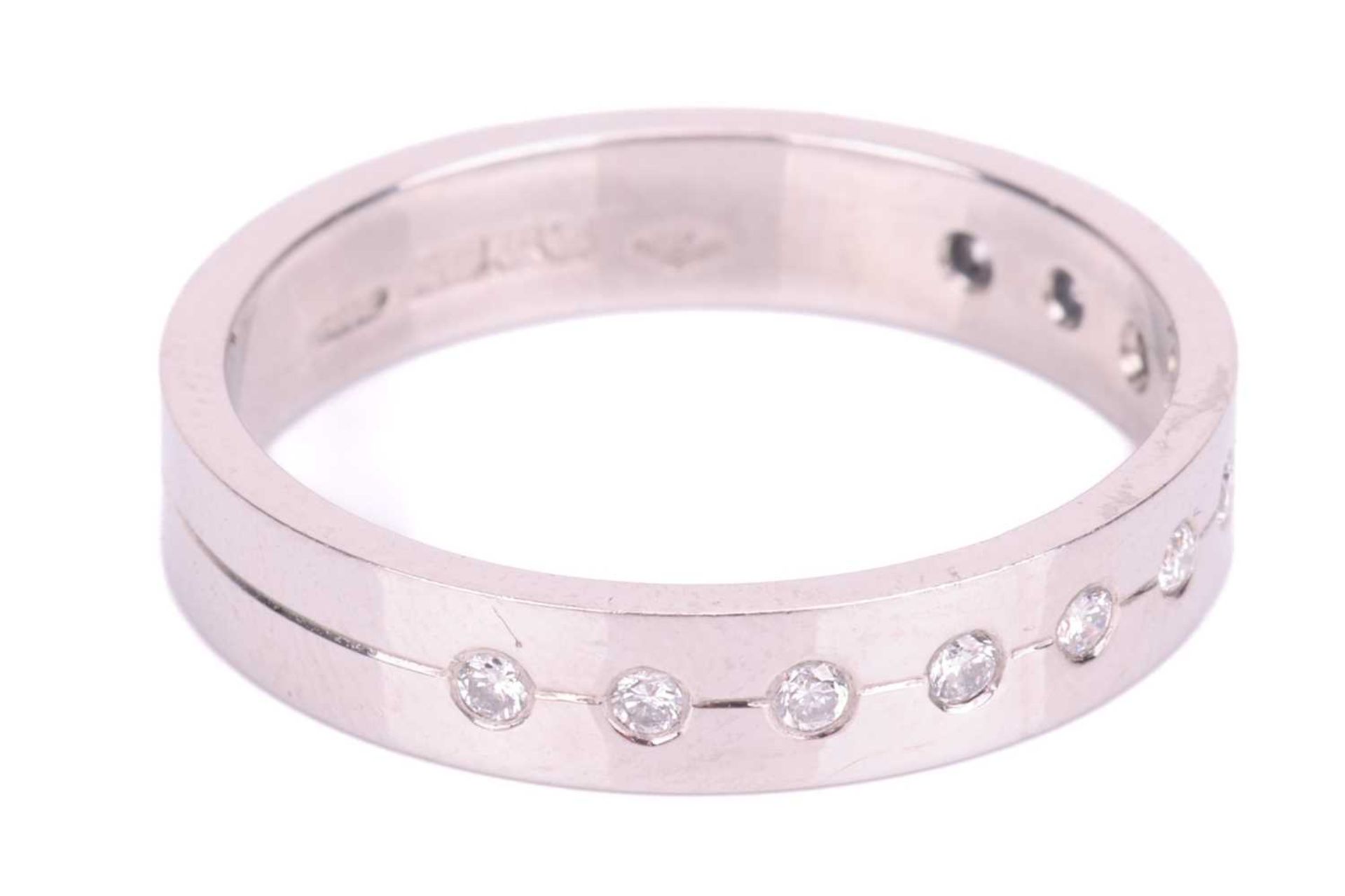 A diamond half eternity ring in platinum, set with a central row of eleven round brilliant cut diamo - Image 2 of 5