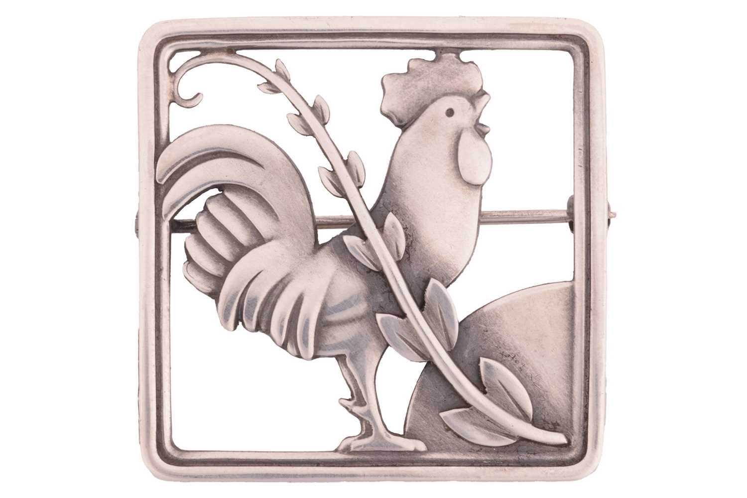 Georg Jensen - A cockerel brooch, depicting a cockerel with fern accent in a square frame, with hing