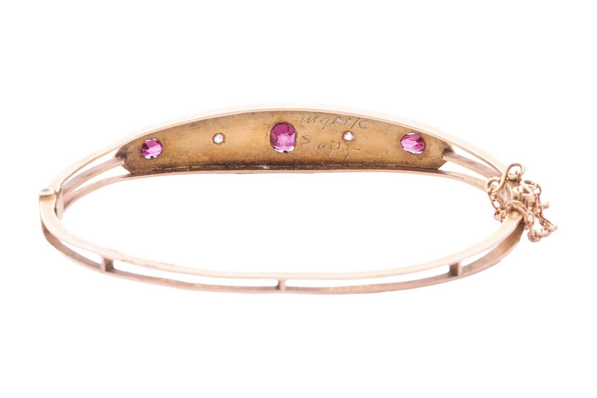 A late Victorian pink sapphire and diamond hinged bangle, front panel star-set with three graduated  - Image 3 of 4