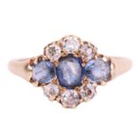 An early 20th-century sapphire and diamond cluster ring, set with three graduated oval-cut sapphires