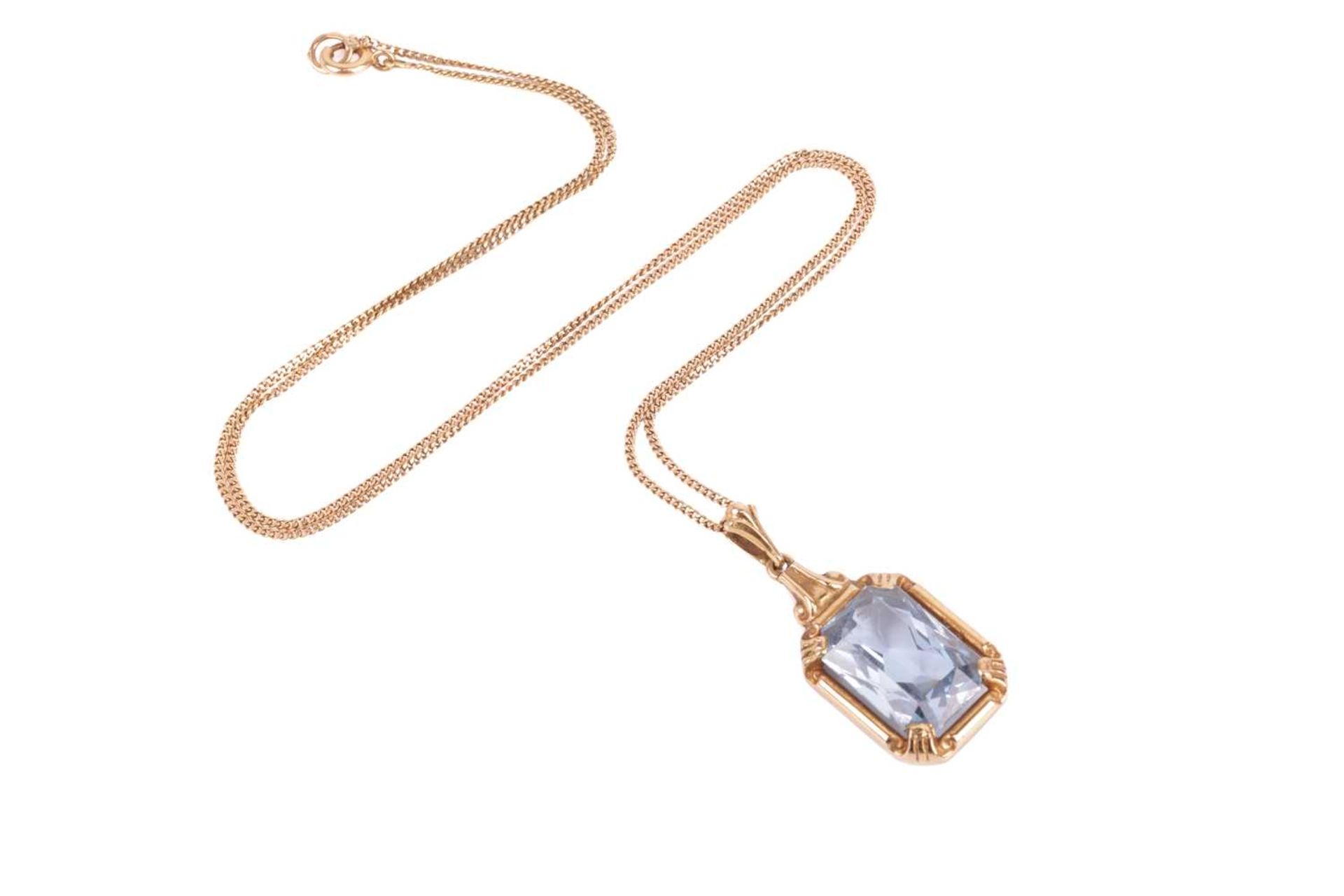 A Swedish single stone synthetic blue spinel pendant, the mixed-cut rectangular stone in four corner